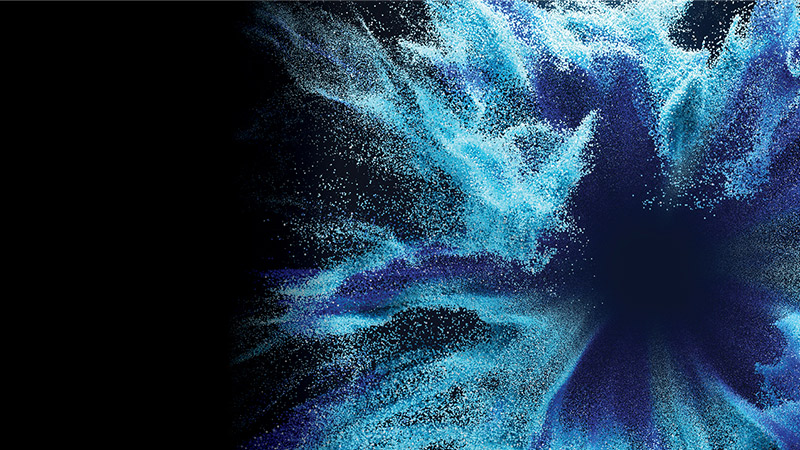 Dynamic abstract splash of cyan and indigo particles on a dark background, forming a swirling burst with a deep center and left‑side negative space.