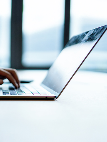 asian businessman working in modern office on laptop