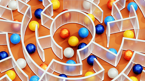 Digitally generated image of glass maze with multicoloured spheres.